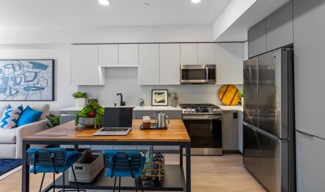 Settle into comfort at The Emery a kitchen with a laptop on a table