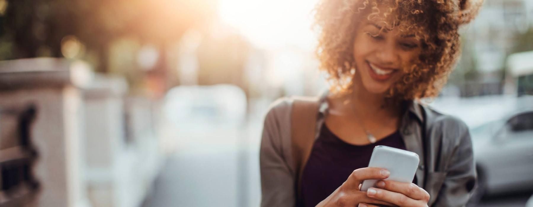 Find your perfect fit at The Emery woman texts on her phone as she walks through the city